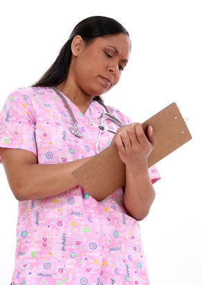 Stock Photograpy: Beautiful Pediatric Nurse Writing On Clipboard