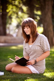 Student with Journal in Park